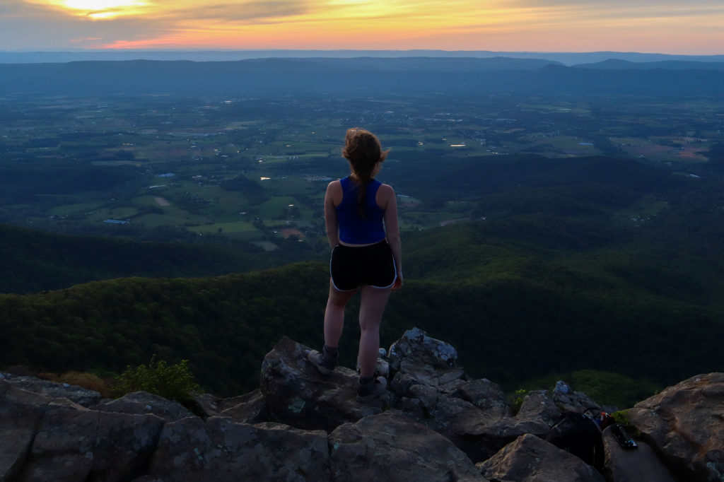 Hiker at Stony Man Mountain during sunset in Shenandoah National Park